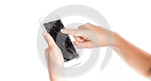 Angry little girl holding a smartphone with broken screen