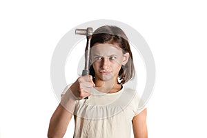 Angry little girl holding a socket wrench