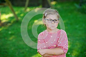 Angry little girl on outdoors. Sad upset preschool child.