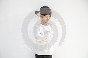 Angry little girl over white background, sign and gesture concept