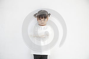 Angry little girl over white background, sign and gesture concept