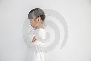 Angry little girl over white background, sign and gesture concept