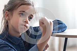 Angry little girl shows her fist, showing strength