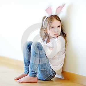 Angry little girl wearing bunny ears