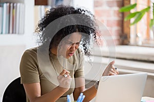 Angry mad african businesswoman feeling crazy furious hates stuck laptop