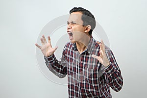Angry mad asian indonesian man with pointing finger gesture on isolated background