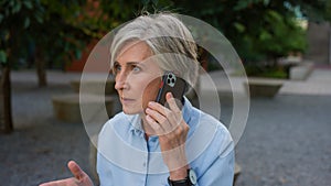 Angry mad senior businesswoman Caucasian old woman stressed female argue talking mobile phone dissatisfied mature