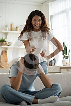 Angry mad woman mother disciplining-teen girl daughter at home, parent scolding teenage kid photo