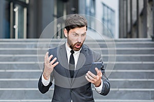 Angry male businessman cry talking on the phone outside business man shouting on call outdoors. Nervous mad professional