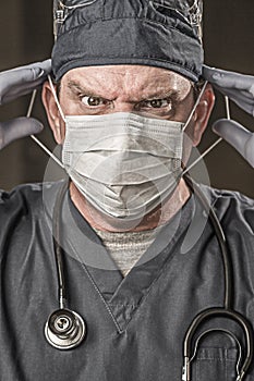 Angry Male Doctor or Nurse Wearing Scrubs, Protective Face Mask and Goggles