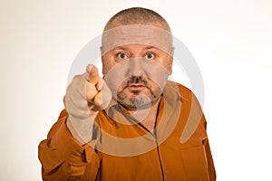 An angry man with beard pointing finger at you