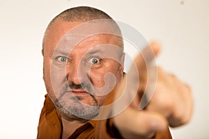 An angry man with beard pointing finger at you