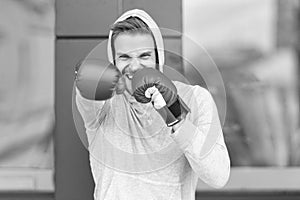 angry man boxing. man boxing in hoodie and gloves. man boxing outdoor.