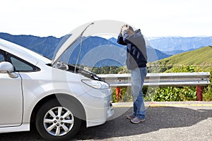 Angry man with breakdown car photo