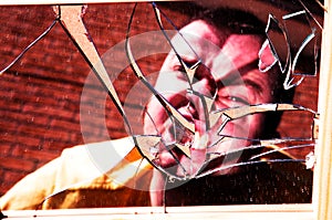 Angry man in broken glass
