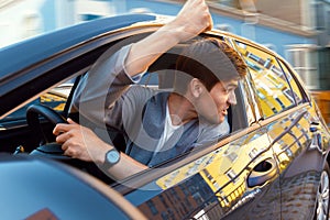 Angry man at car in traffic jam