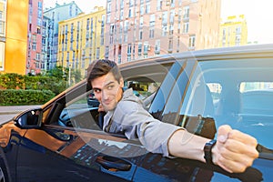 Angry man at car in traffic jam