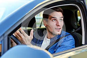 Angry man at car in traffic jam