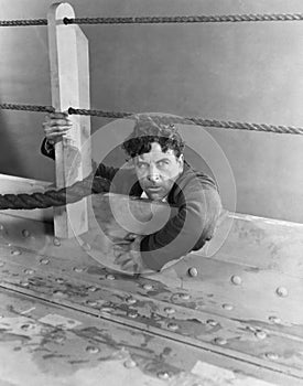 Angry man climbing aboard boat