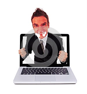 Angry man coming out from laptop