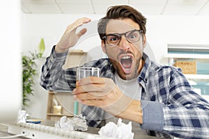 angry man at computer making violent gesture