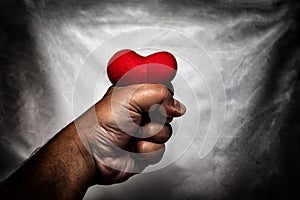 angry man crushing red heart in hand., unrequited love., love co