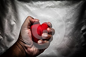 angry man crushing red heart in hand., unrequited love., love co photo
