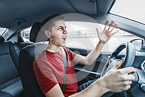 Angry man driver reacts aggressively to road users. Concept of psychological problems, anger, and traffic accidents