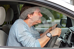 Angry man driving car