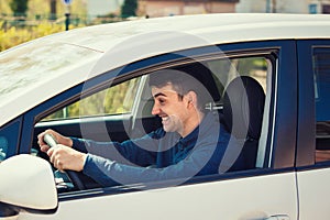 Angry man driving a vehicle. Irritated and furious man holding the steering wheel tight, grinding teeth