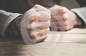 Angry man fists in the table. photo