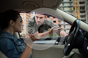 angry man gesturing to driver through