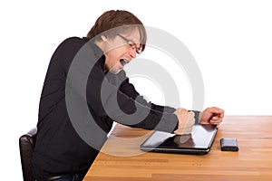 Angry man knock with his fist on his laptop