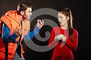 Angry man lifeguard shouting at woman lifesaver.