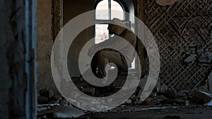 An angry man in an old ruined building. Sad person, problems at work or in life, a person who is depressed.