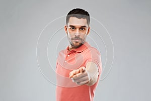 Angry man pointing finger to you over gray