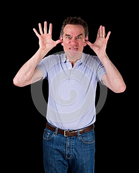 Angry Man Poking Out Tongue with Hands in Ears photo
