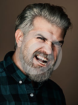Angry Man. Portrait of a happy man over gray background. Fashion style portrait of handsome guy. Handsome young man on