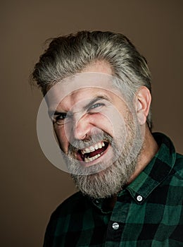 Angry Man. Portrait of a happy man over gray background. Fashion style portrait of handsome guy. Handsome young man on