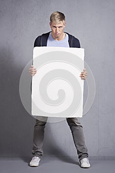 Angry man presenting white blank panel.