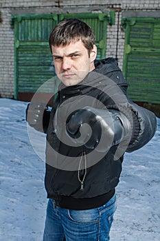 Angry man punching in a street fight.