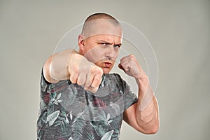 Angry man punching towards camera