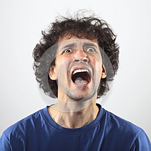 Angry man screaming at somebody, worried and shocked young man