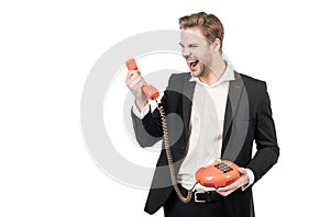Angry man shout in vintage telephone receiver holding old-fashioned landline phone, telephony
