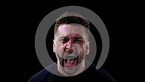 Angry man shouting on dark background, emotional breakdown, outburst neurosis