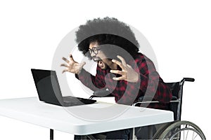 Angry man shouting at his laptop