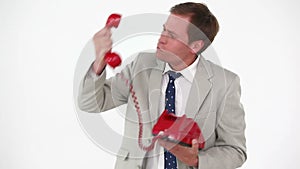 Angry man shouting in a red phone