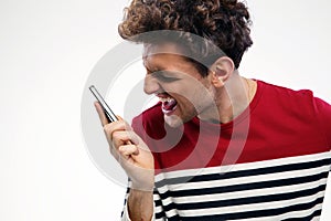 Angry man shouting at smartphone