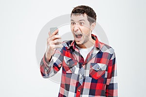 Angry man shouting on smartphone