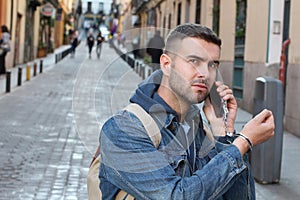 Angry man showing extreme dependency with his smartphone